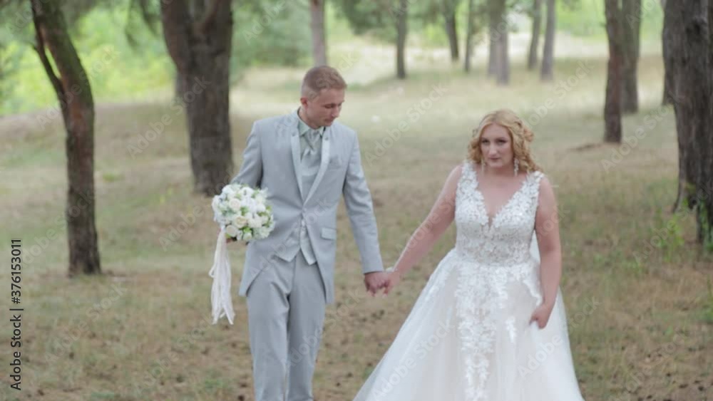 Very beautiful bride and groom are walking in the forest in summer. Very beautiful bride and groom are walking in the forest in summer.