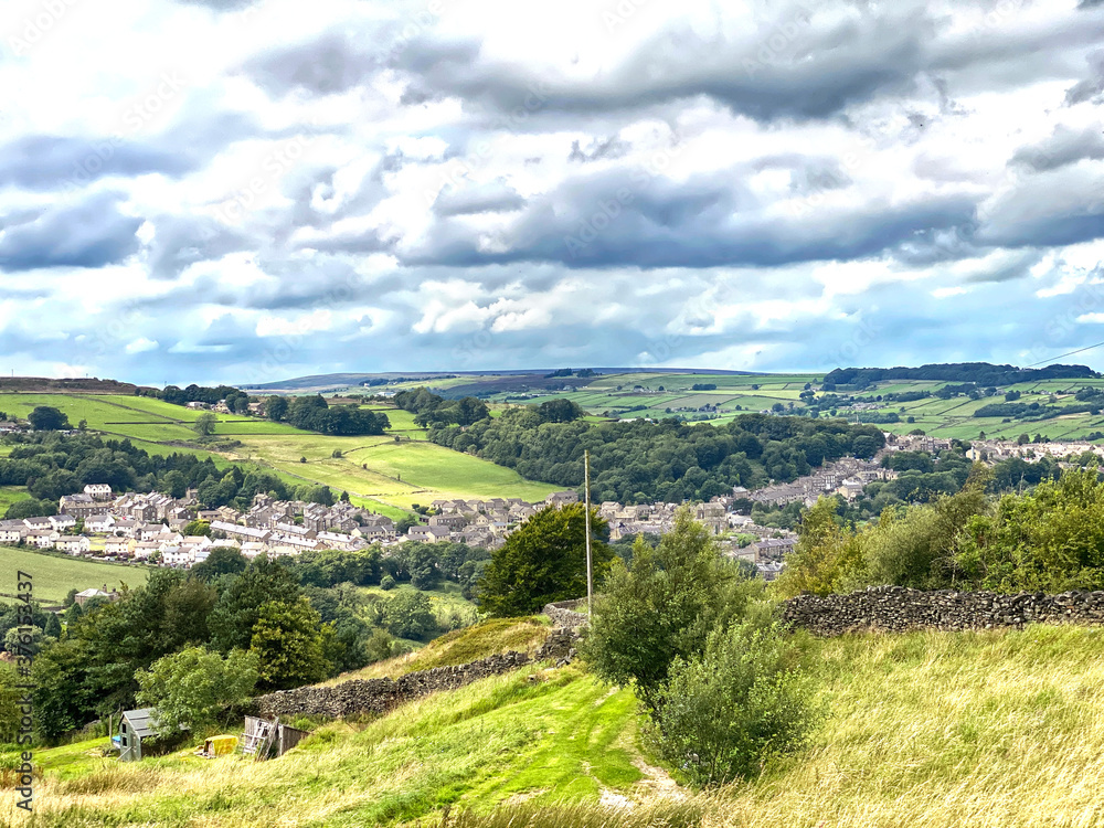 Looking toward Haworth, from the moor top, with grass, houses and trees in, Haworth, Keighley, UK