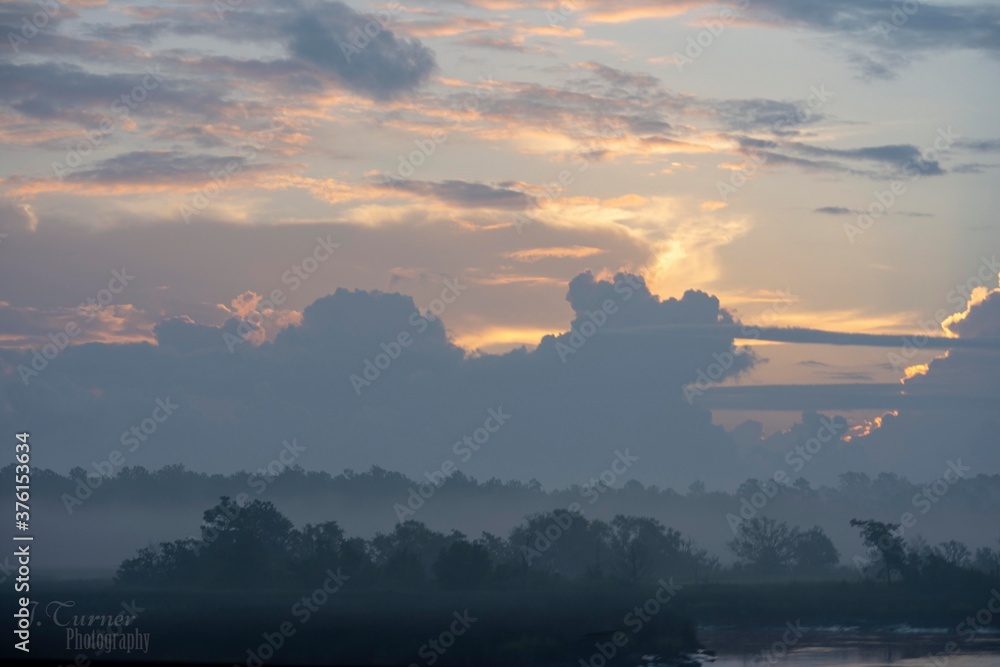 rising sun hidden by clouds