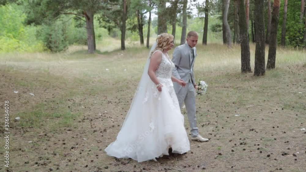 Very beautiful bride and groom are walking in the forest in summer. Very beautiful bride and groom are walking in the forest in summer.