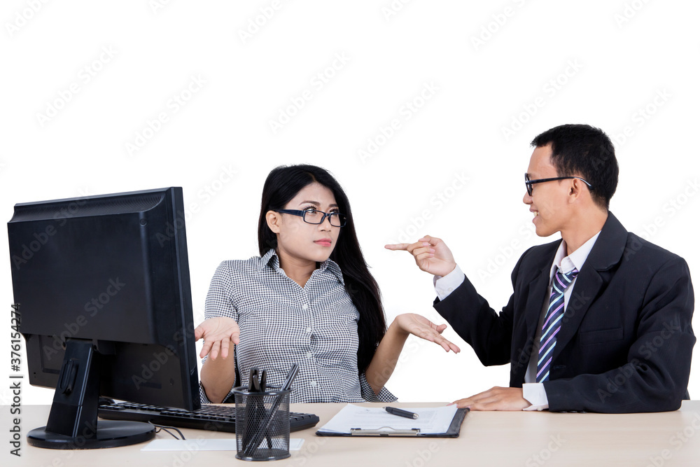 Businessman scolding at her confused subordinate Businessman scolding at her confused subordinate