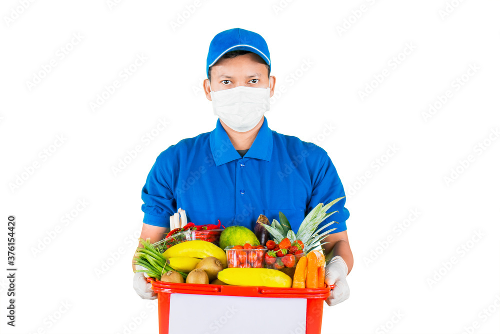 Male courier wear mask while holding vegetables Male courier wear mask while holding vegetables