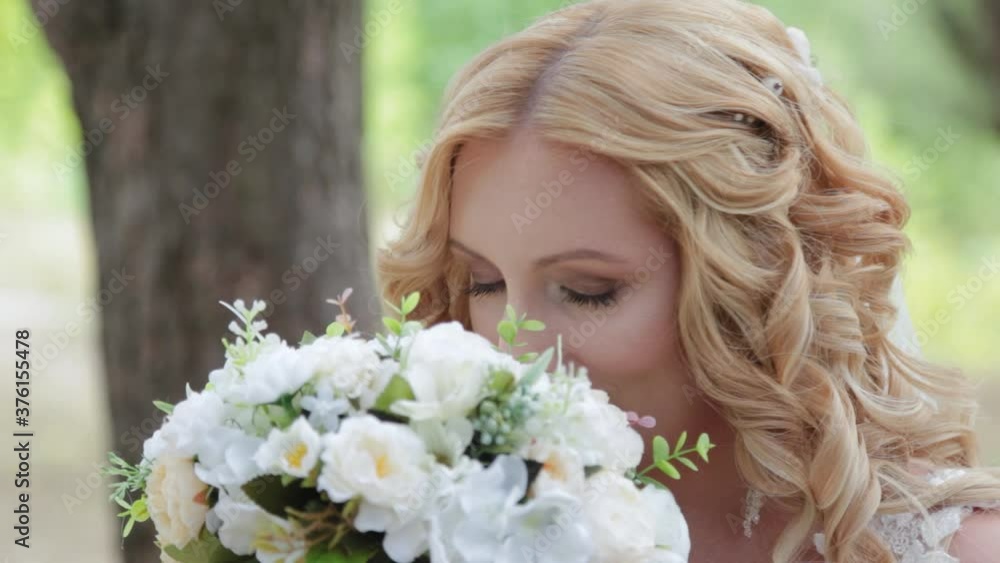 Bride with wedding bouquet in green summer forest. Bride with wedding bouquet in green summer forest.