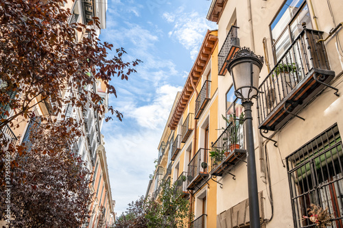 Beautiful street lantern and scenery in the Las Letras neighborhood in central Madrid, with typical Spanish architecture.