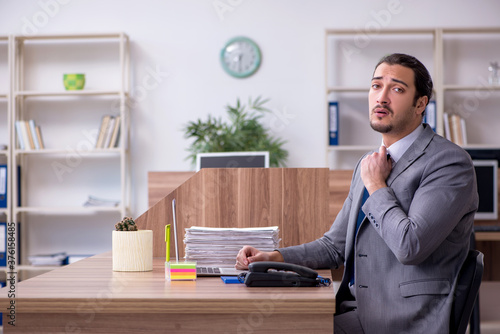 Young male employee working in the office