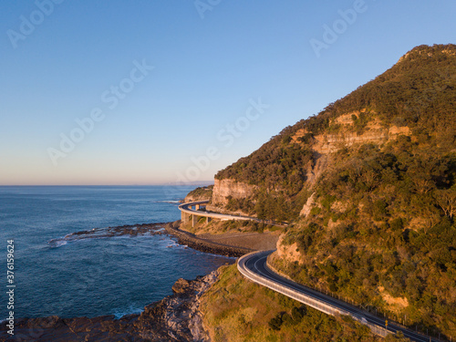 Aerial view of road around the cliff in the coastline.