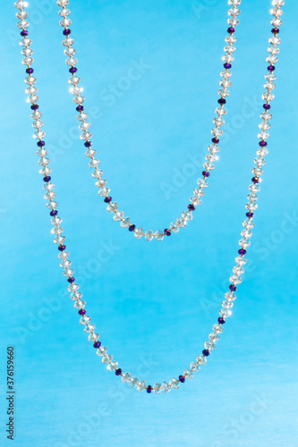 crystal necklace on blue background