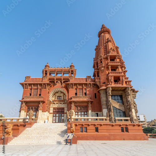 Low angle view of front facade of Baron Empain Palace, a historic mansion inspired by the Cambodian Hindu temple of Angkor Wat, located in Heliopolis district, Cairo, Egypt photo