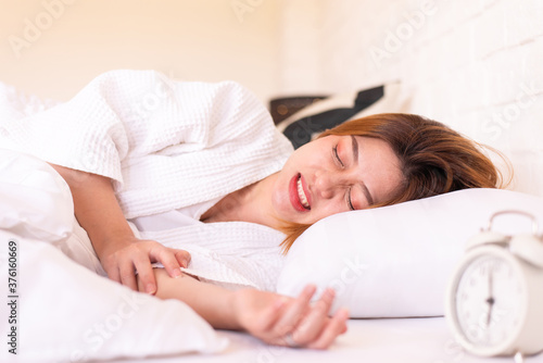 Asian woman sleeping on the bed and grinding teeth,Female bruxism