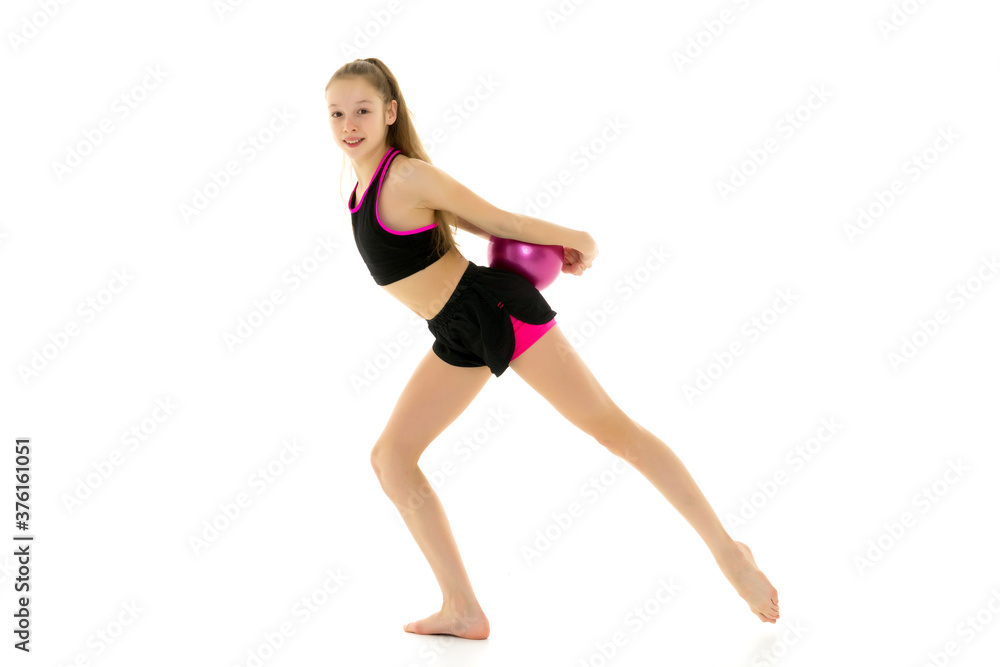 Girl gymnast performs exercises with the ball.