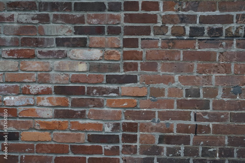 old brick wall with multicolored bricks and old rustic texture pattern