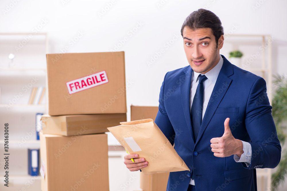 Young male logistics specialist working in the office Young male logistics specialist working in the office
