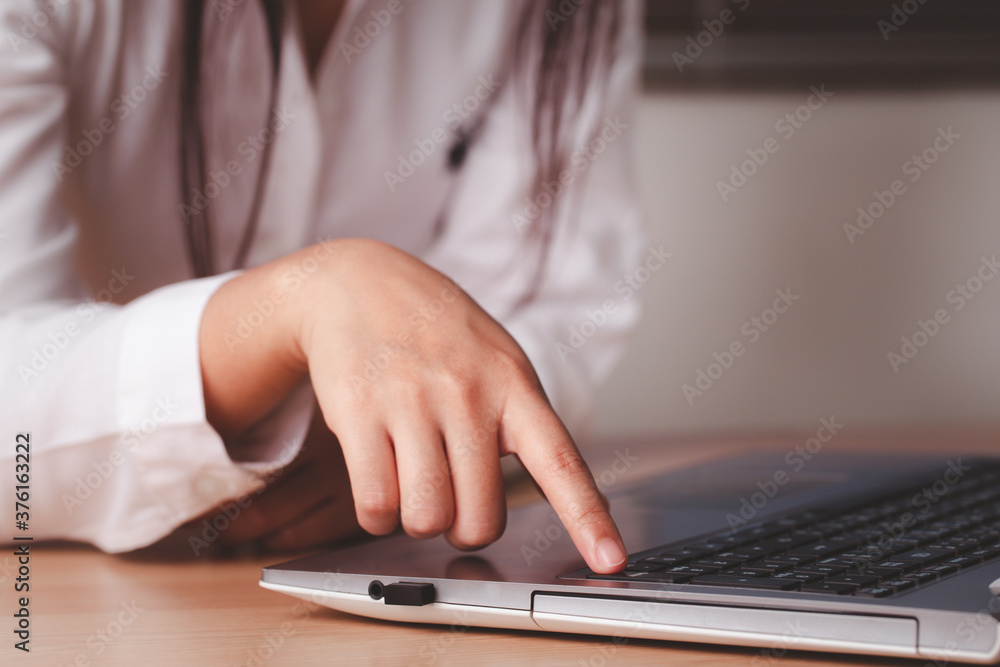 Woman hand are pressing a button to find out online what interests them using their laptop computer. Searching information data on internet networking concept. Woman hand are pressing a button to find out online what interests them using their laptop computer. Searching information data on internet networking concept.