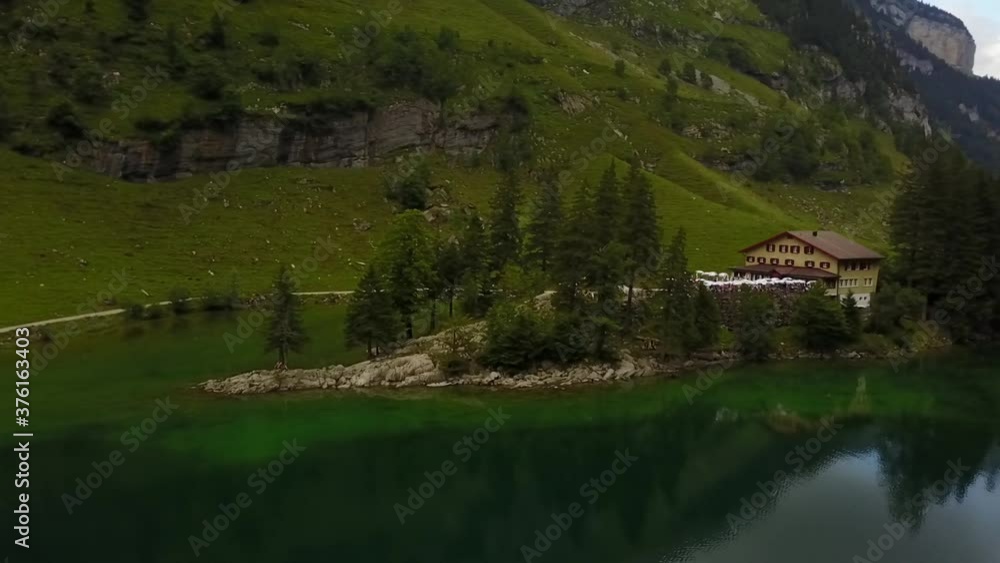 a beautiful left to right flight revealing a mirror image in the clouds in the water and a small boat in the lower thirds a the end of the shot a beautiful left to right flight revealing a mirror image in the clouds in the water and a small boat in the lower thirds a the end of the shot