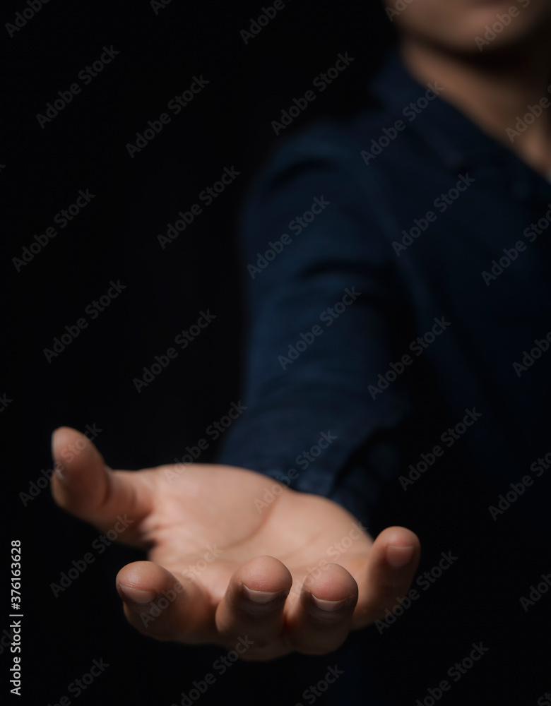 Place your hands face up separately on a black background. The concept is reaching and space available for use, such as yes, text and various effects.