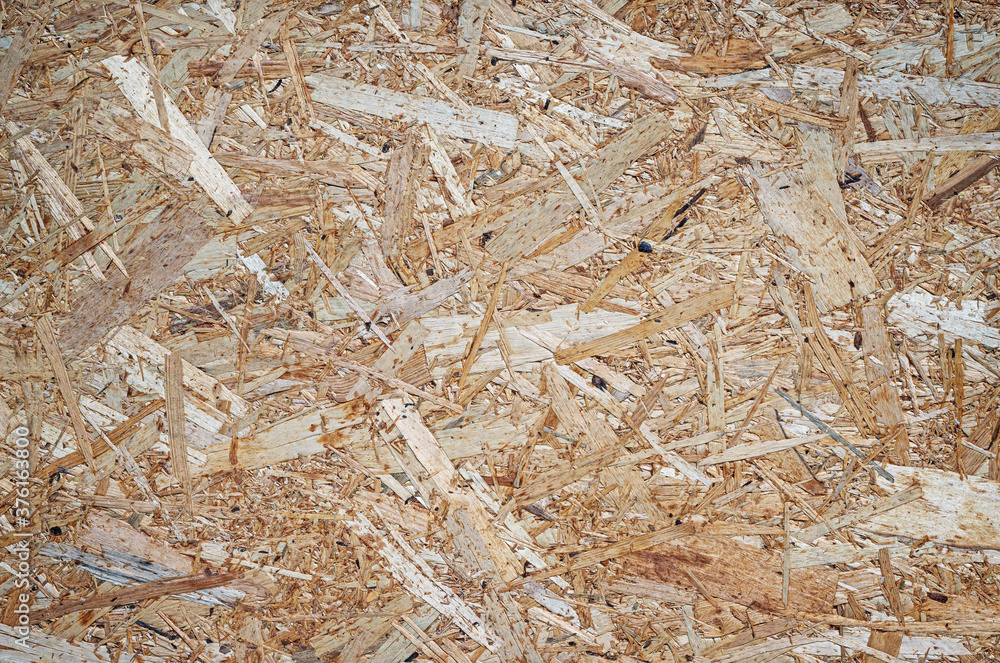 Background of wood chips. Pressed wood chip board texture. Background of wood chips. Pressed wood chip board texture.