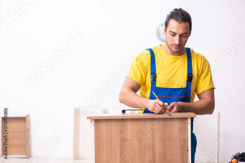 Young male carpenter working indoors