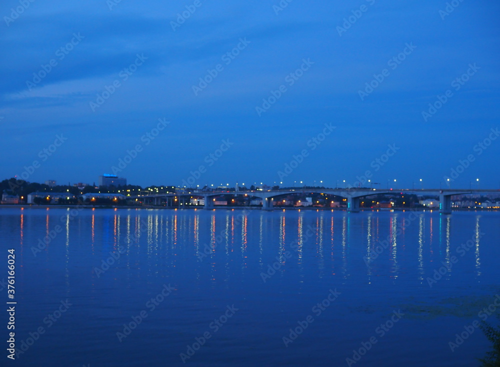 Bridge over the Volga river, evening lighting. river landscape at dusk.