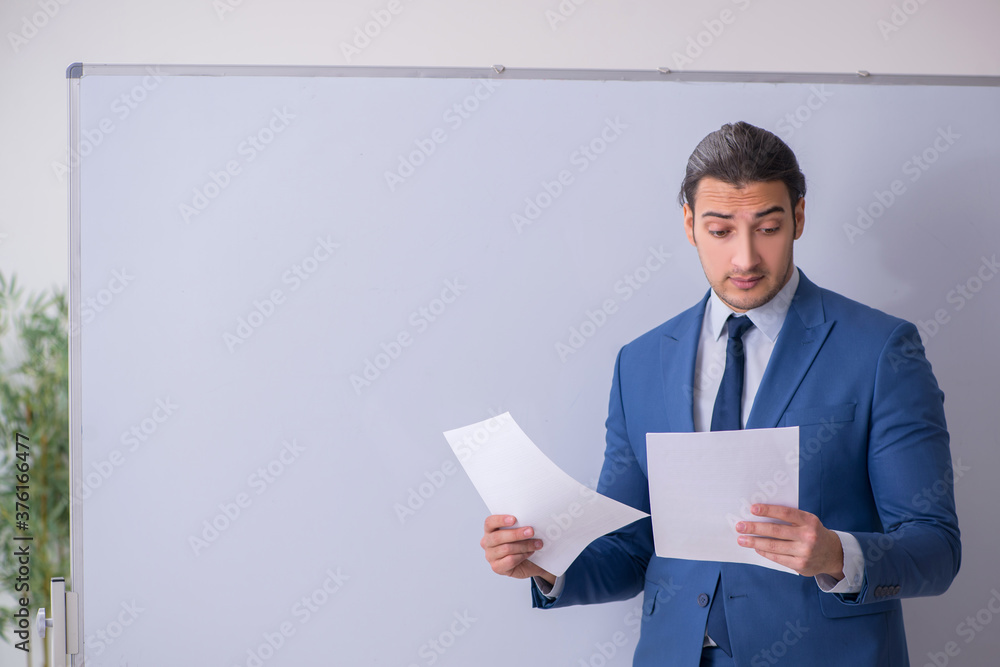 Young man employee in business presentation concept Young man employee in business presentation concept