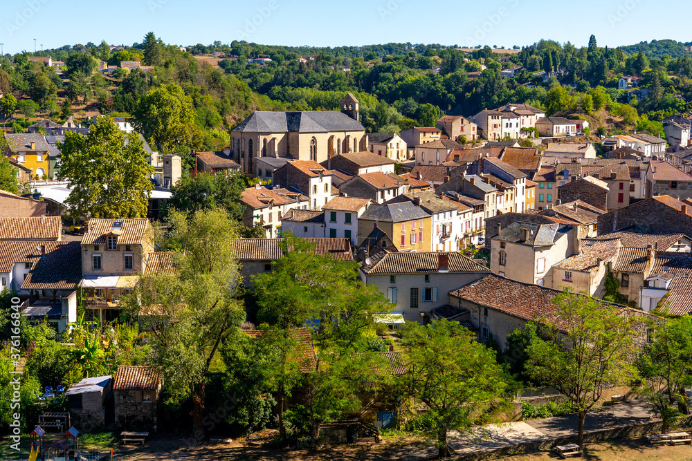 Beautiful top view of the French village of Laguepie. Old catholic cathedral. Orange tiled roofs. 