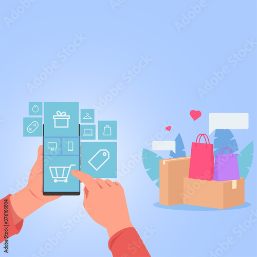 Hand hold phone tap on shopping icon for online shopping. Bags and box around.