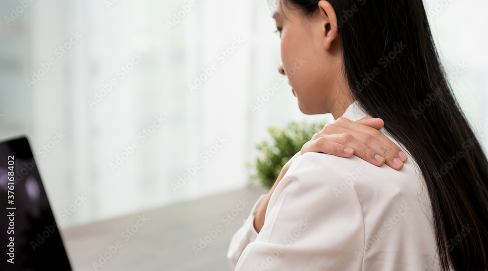 Asian business woman suffers from shoulder pain from working with computers for a long time. Asian business woman suffers from shoulder pain from working with computers for a long time.