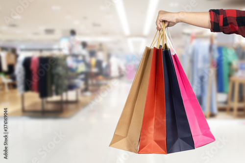 Woman holding shopping bag in mall on black Friday