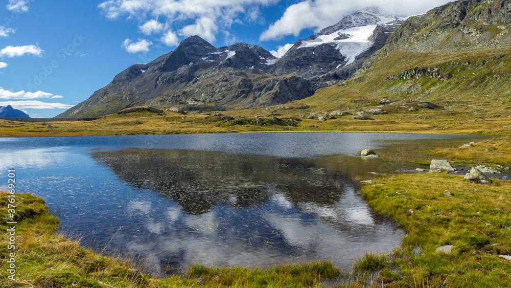 Bernina mountain pass. Wonderful landscape at the Black Lake in summer time. Glacier on the back. Amazing landscape of the Switzerland land. Best of Swiss. Famous destination and tourists attraction