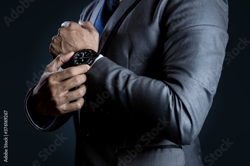 Businessman checking time on watch