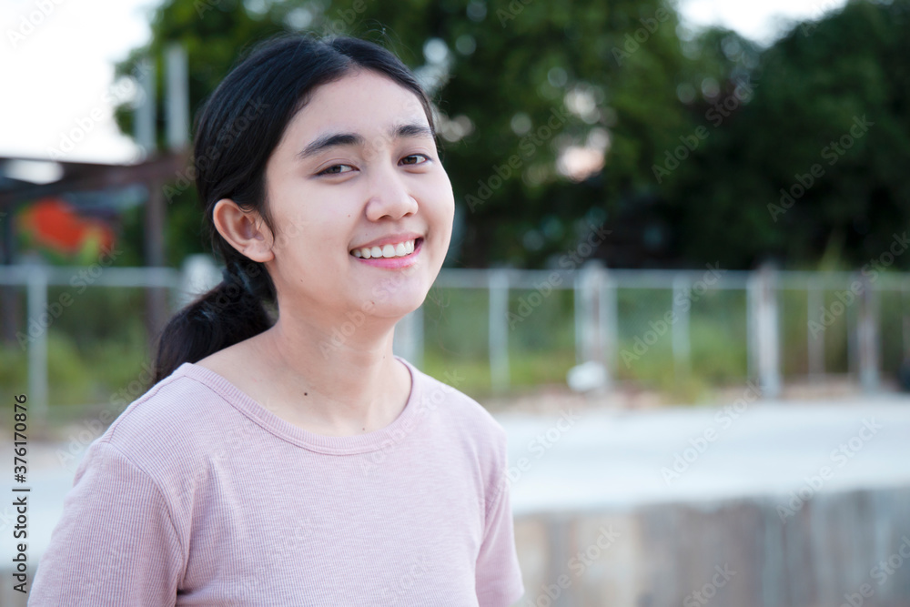 Young Asian women felt happy, smiling and cheerful at the park in the evening of the day. Young Asian women felt happy, smiling and cheerful at the park in the evening of the day.