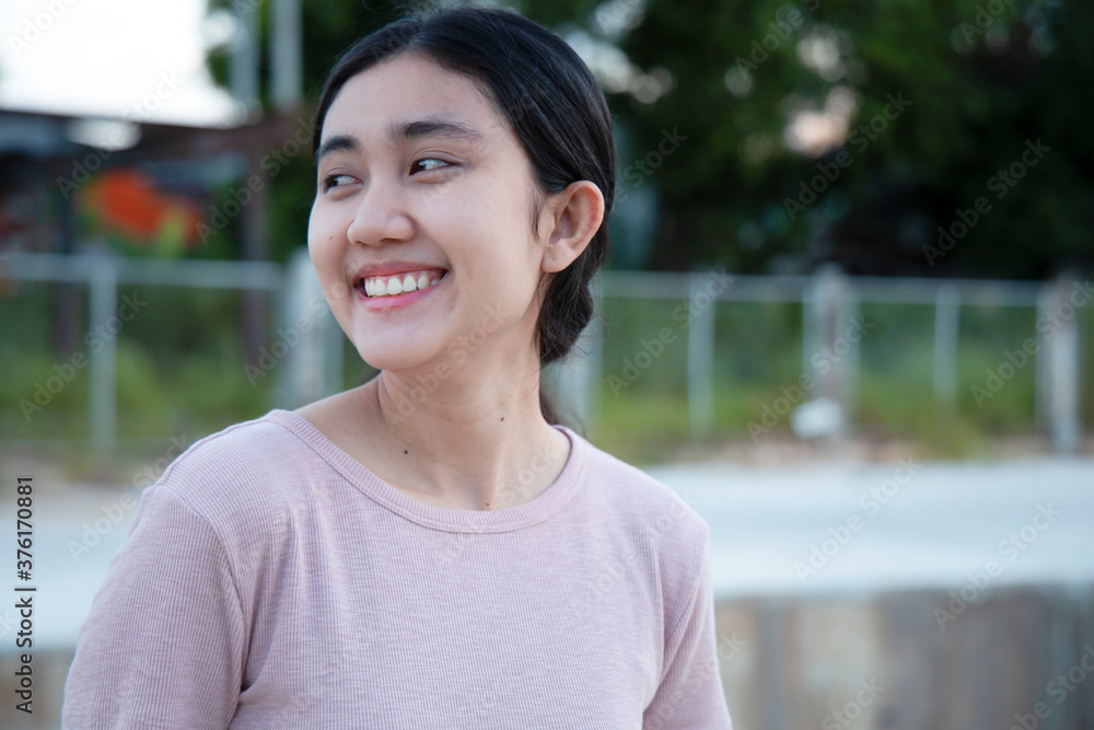 Young Asian women felt happy, smiling and cheerful at the park in the evening of the day. Young Asian women felt happy, smiling and cheerful at the park in the evening of the day.