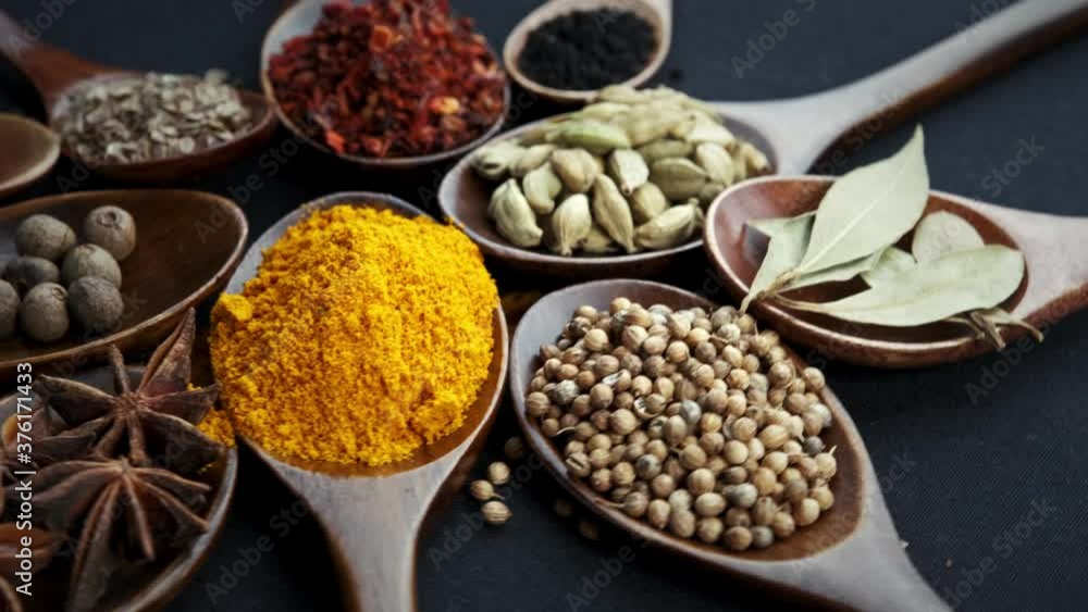 Various Indian Spices of rotation black background. Various Indian Spices of rotation black background.