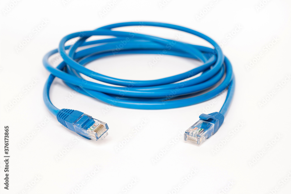 Blue patchcord with RJ45 plug lan network isolated on white background. Blue patchcord with RJ45 plug lan network isolated on white background.