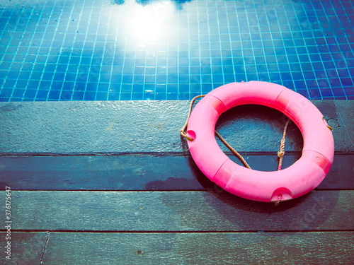 pink pool float, ring floting in blue swimming pool.relaxing day in summer.