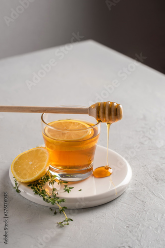 Autumn and winter traditional drinks. Warming hot tea with lemon, honey and thyme. Healthy drink