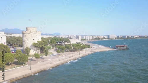 Historic Architecture Of White Tower Of Thessaloniki At The Waterfront City Of Thessaloniki, Greece From The Thermaic Gulf On A Sunny Summer Day. - aerial drone shot
 photo