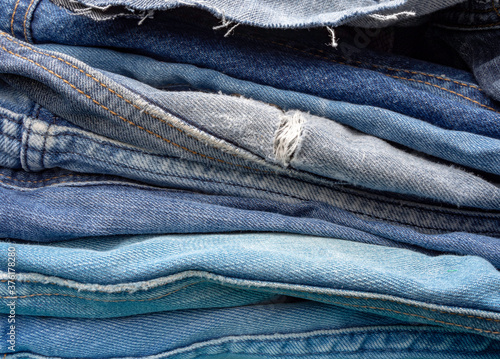 A pile of old blue jeans ready to be recycled in the circular economy. 