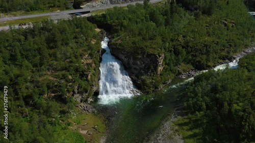 Aerial view around the Rovijokfossen waterfall and the Ivgojohka river, on a sunny, summer day, in Skibotndalen, in Storfjord, Norway - orbit, drone shot, photo