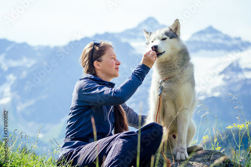 Dog with a woman walking mountains outdoors © yurakrasil