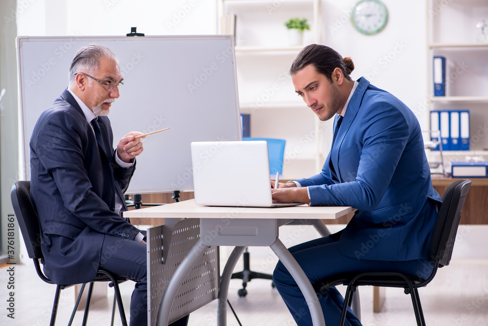 Yound and old employees in business presentation concept Yound and old employees in business presentation concept