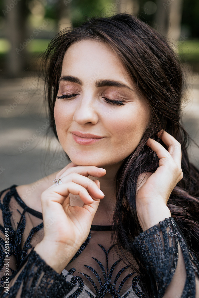 Portrait of smiling woman wearing black white fashion dress and close eyes Portrait of smiling woman wearing black white fashion dress and close eyes