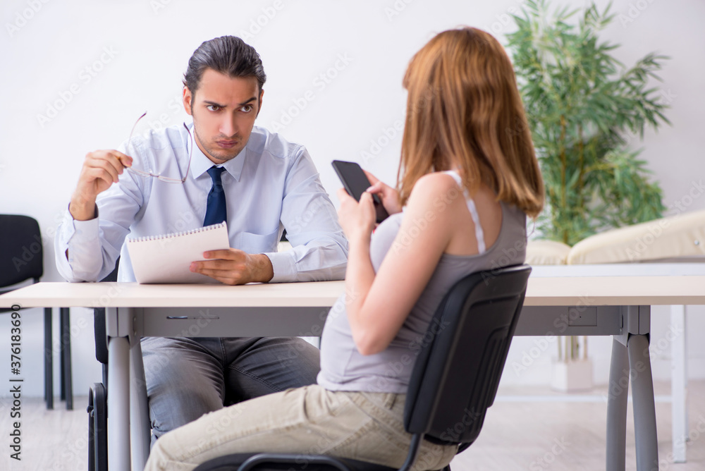 Pregnant woman visiting male psychologist doctor Pregnant woman visiting male psychologist doctor