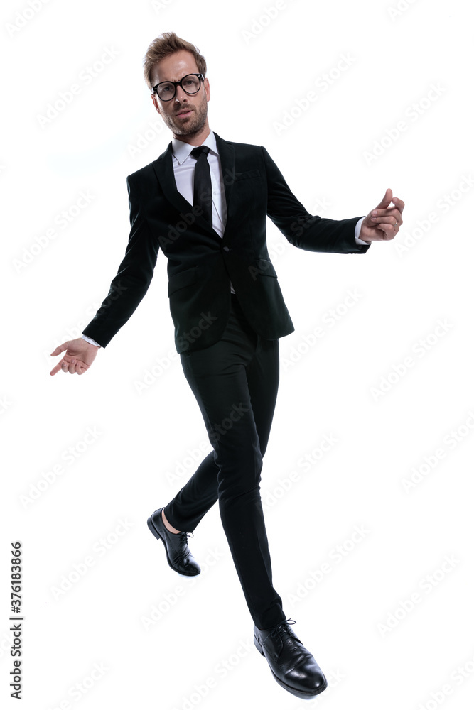 dramatic cool man in black suit opening arms dramatic cool man in black suit opening arms