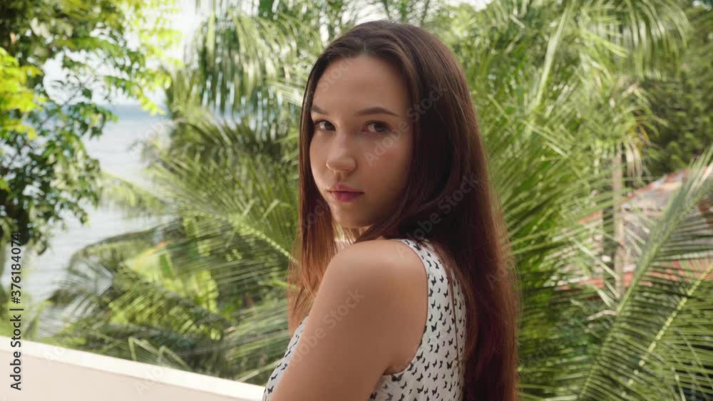 Portrait of a beautiful caucasian brunette woman with long hair. Woman enjoying the beauty of nature. Portrait of a beautiful caucasian brunette woman with long hair. Woman enjoying the beauty of nature.