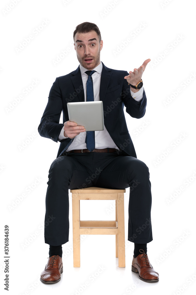 Nervous businessman holding tablet and being afraid Nervous businessman holding tablet and being afraid