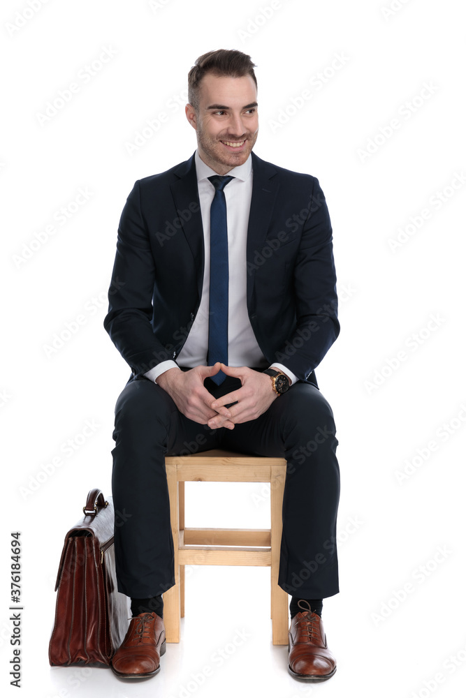 Excited businessman playing with his hands and looking away Excited businessman playing with his hands and looking away