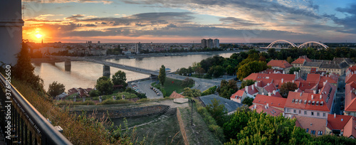View of the city of Novi Sad and the Danube river, the city of Petrovaradin at sunset from the fortress. Panorama banner format photo