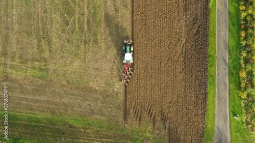 Tractor plowing a big field in the spring time, drone stock footage by DroneRune 3 photo