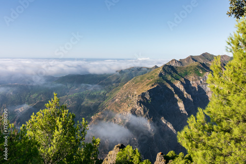 Views of the Sierra Almijara, Tejeda and Alhama from the viewpoint of the highway of the goat, with low clouds that cover the tops of the mountains, creating a panoramic view of a sea of clouds. photo