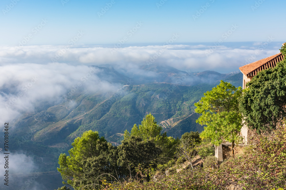 Views of the Sierra Almijara, Tejeda and Alhama from the viewpoint of the highway of the goat, with low clouds that cover the tops of the mountains, creating a panoramic view of a sea of clouds.